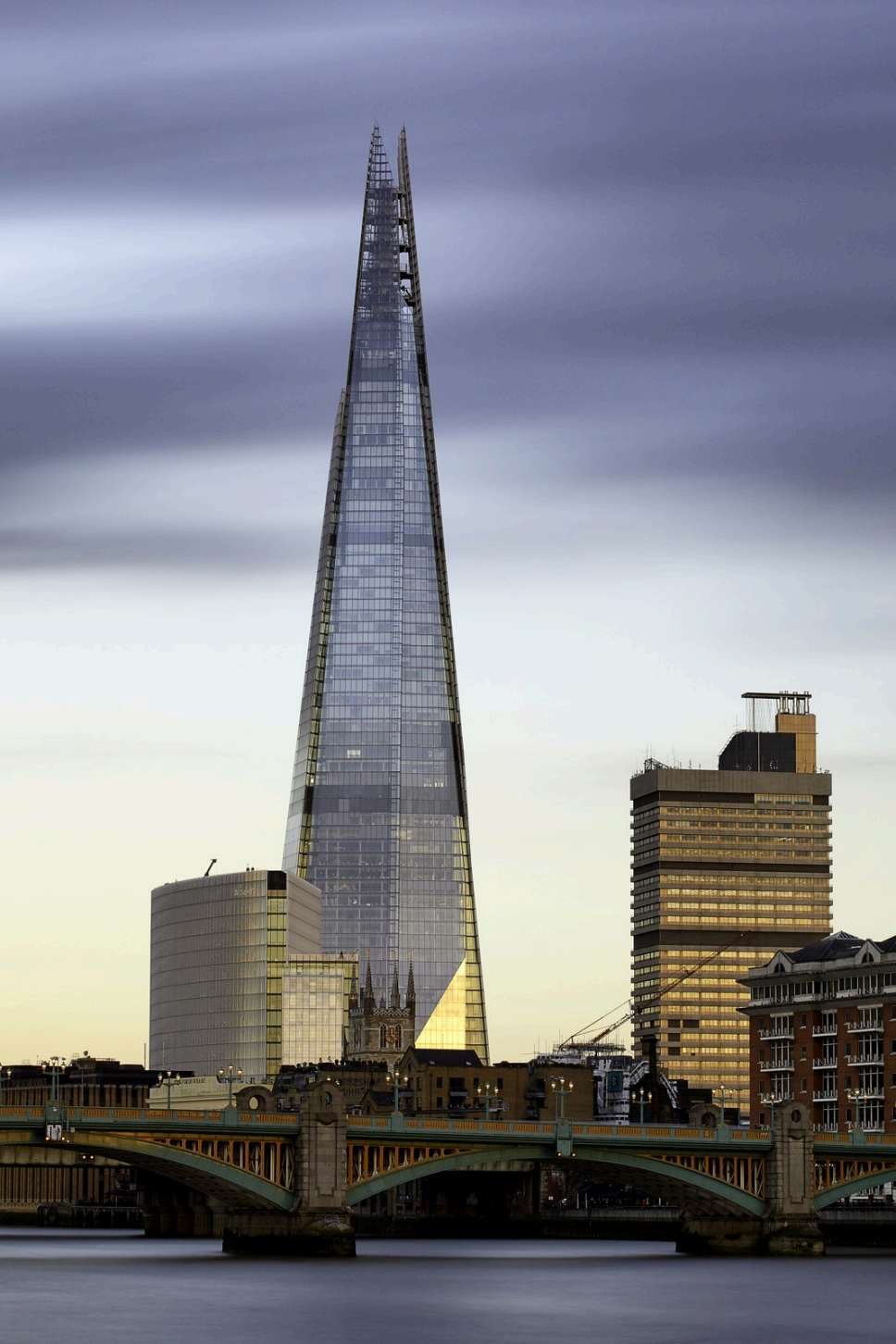 The Shard skyscraper rising above London Bridge at dusk